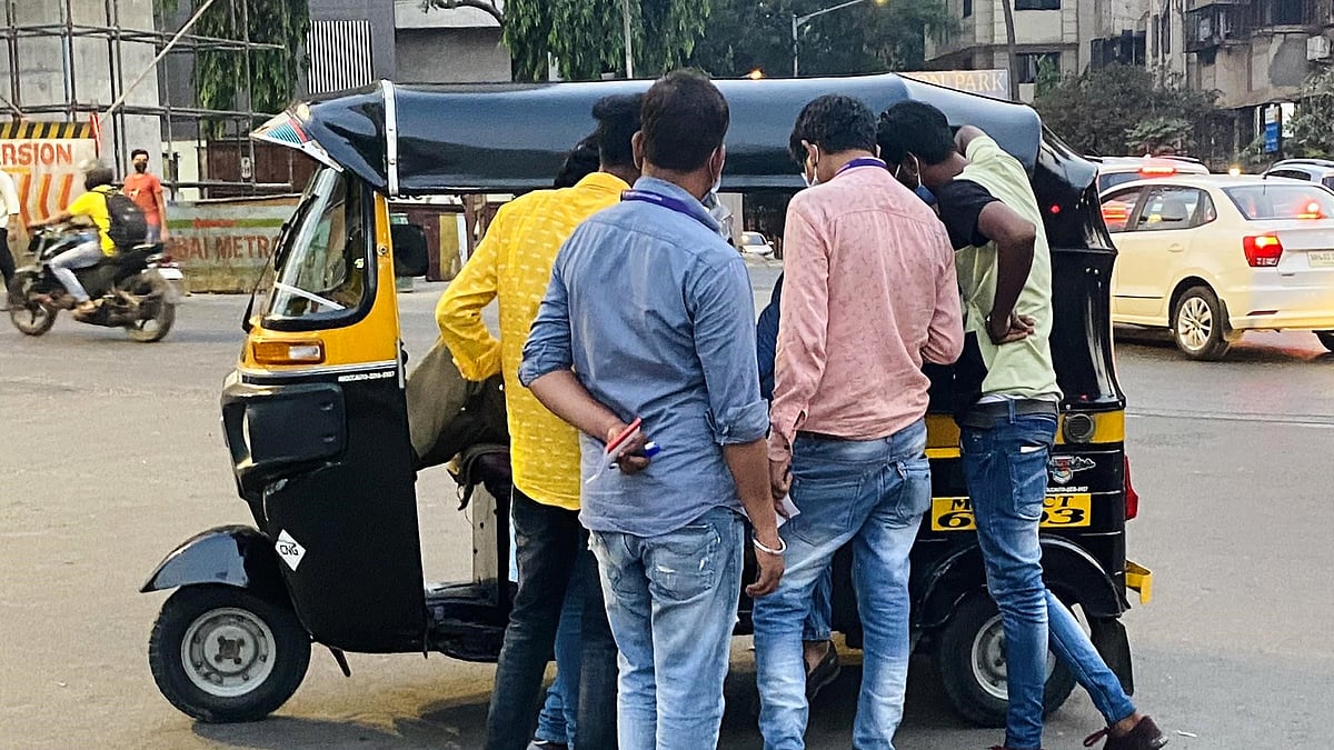 Private fine collectors gather to write up an autorickshaw passenger in Mumbai. 