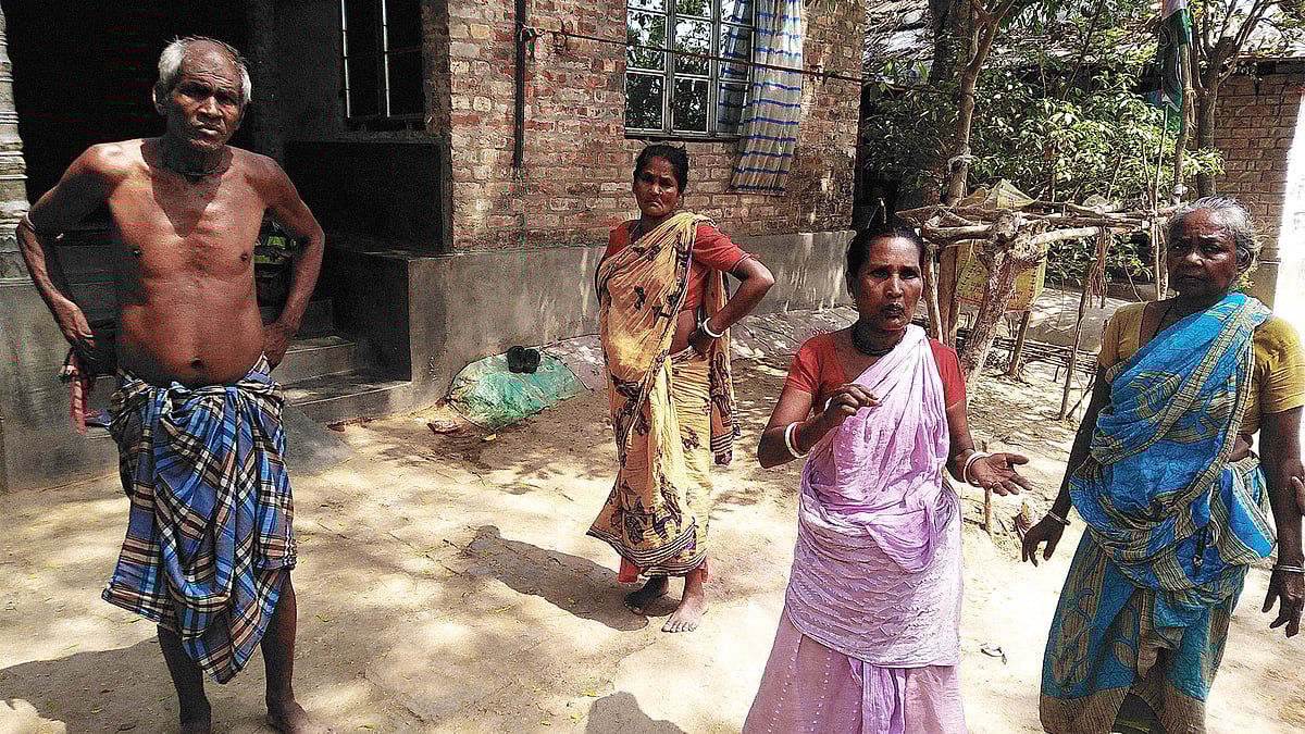 Himela Das, in pink sari, with fellow villagers. 