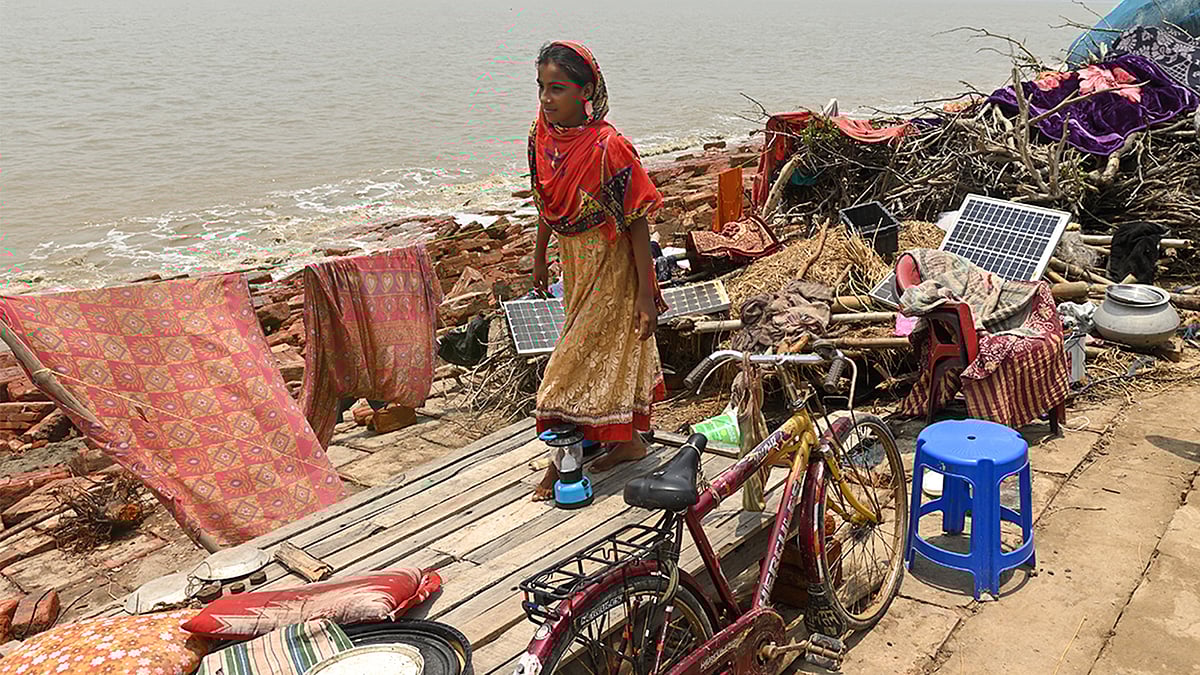 A tidal wave generated by Yaas leaped over a 30-foot concrete embankment and flooded Mousuni. This girl lost her home.