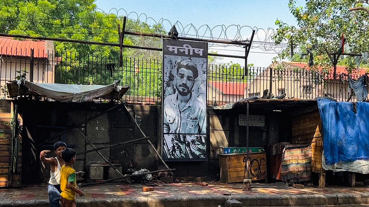 A poster of Manish Kumar at the entrance to the colony.