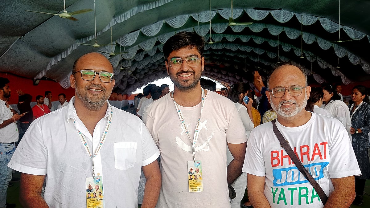 Darshan Mondkar, left, and Niranjan Takle, right, with civil society volunteer Ali Bhojani. 