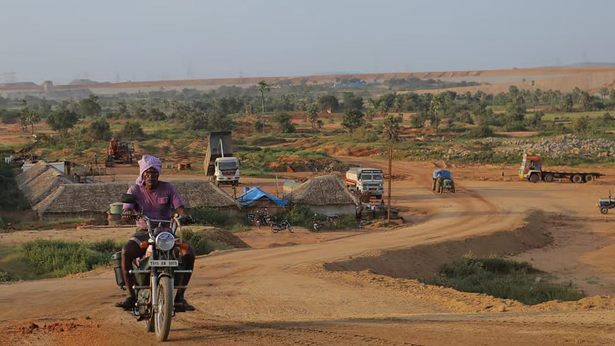 An old man driving a bike on a road at Kaleshwaram project.