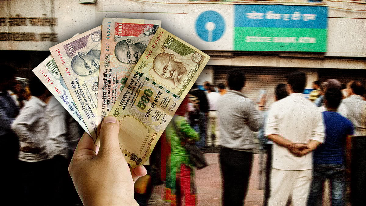 A hand holds old currency notes, before queues outside banks.