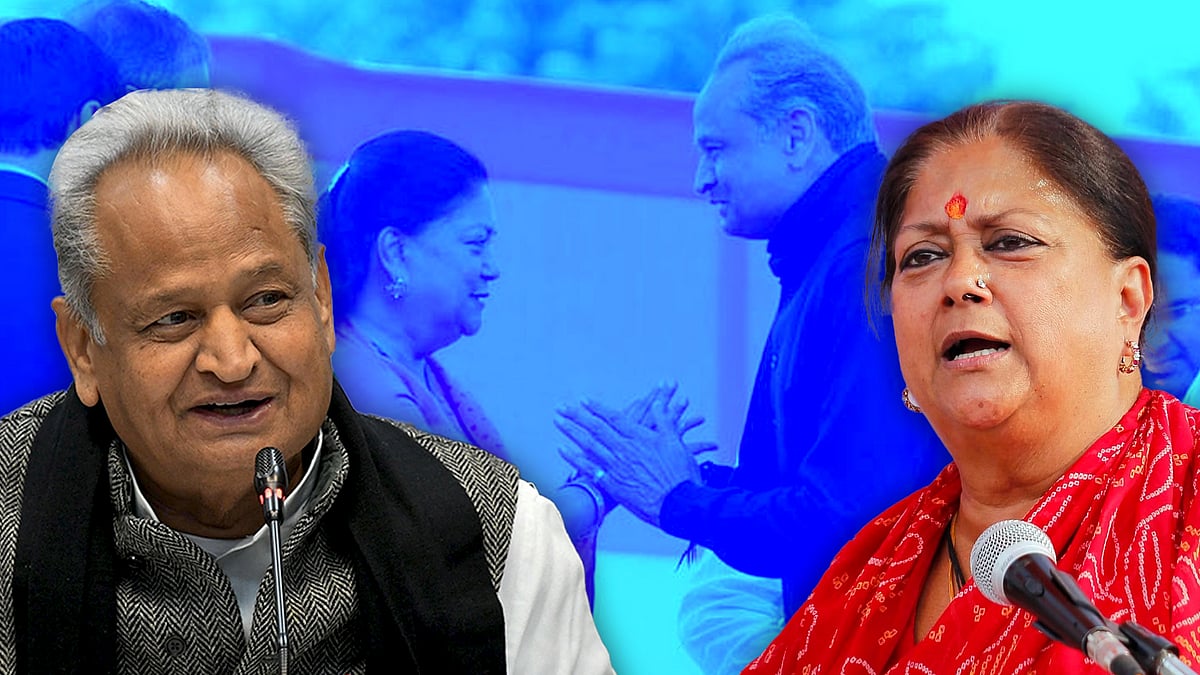 Cutouts of Gehlot and Vasundhara Raje with a picture of them together at an event in the background.