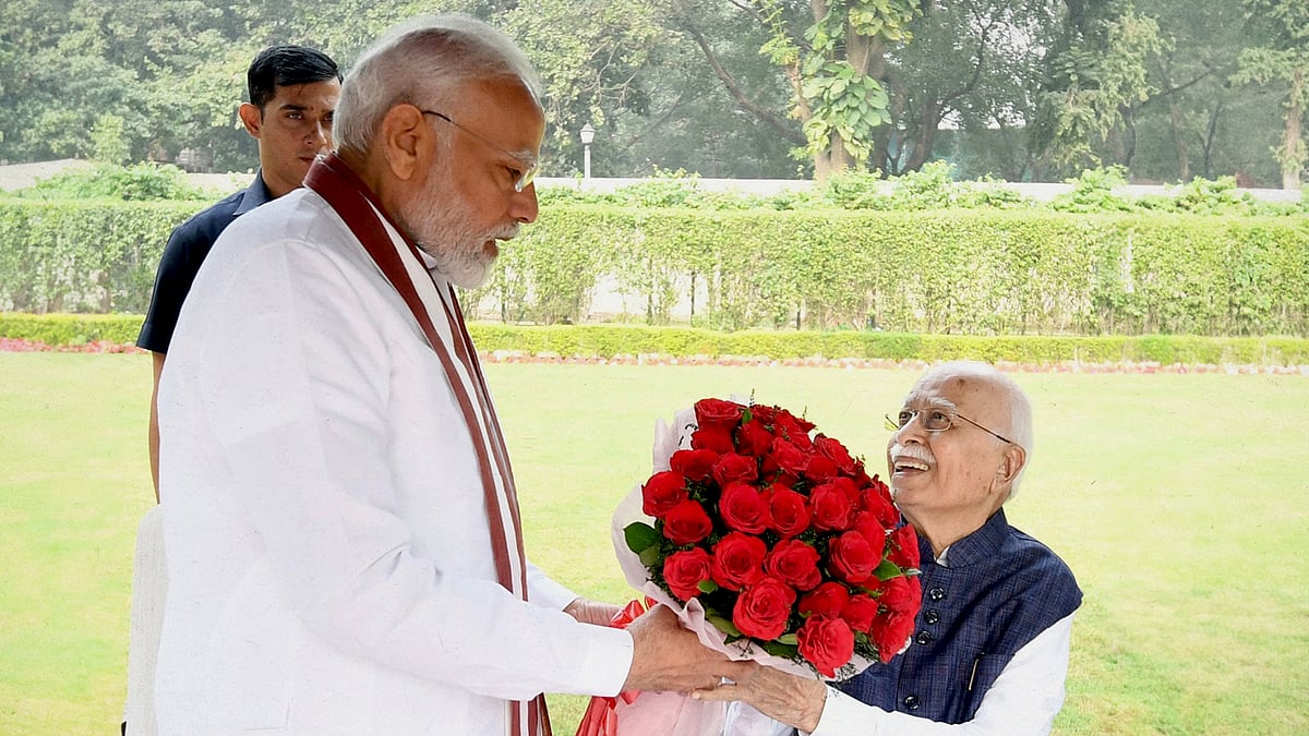 Modi presenting a bouquet to Advani. 