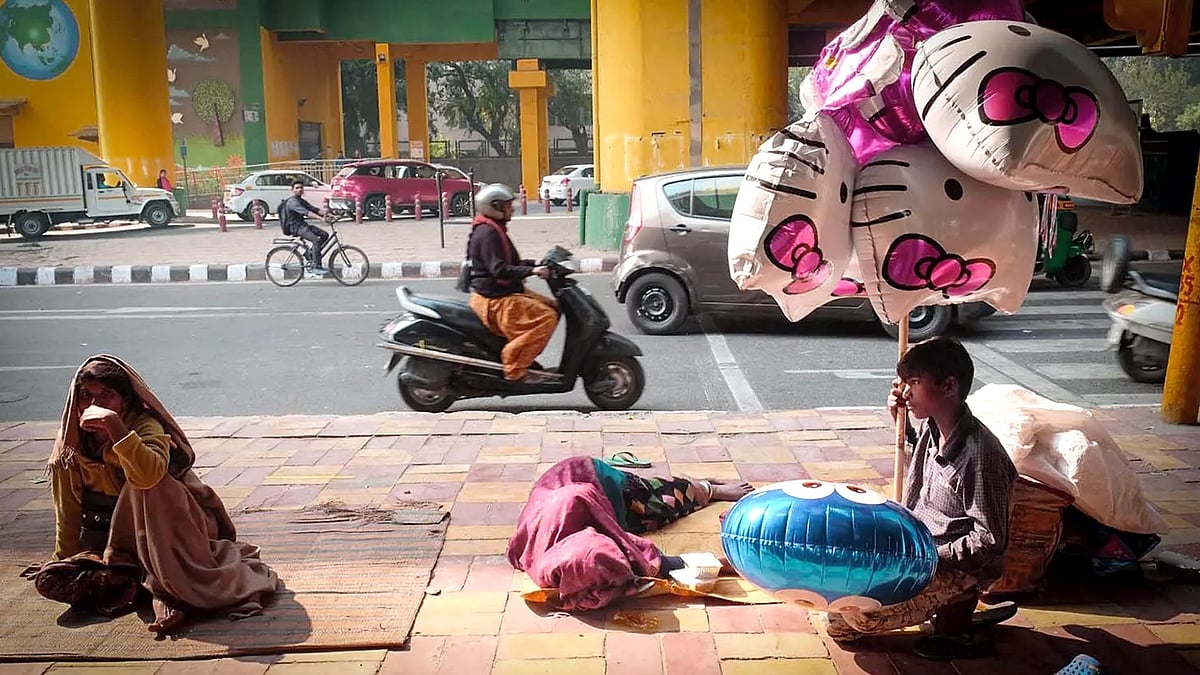Homeless people on a pavement in Delhi.