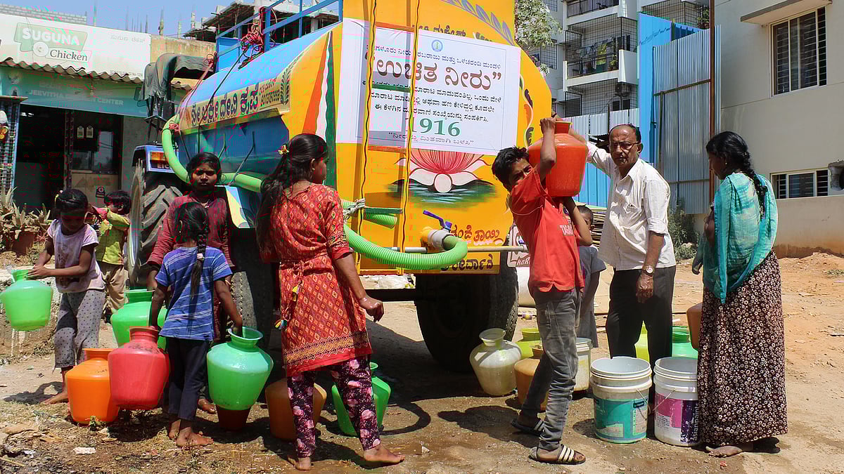 People around a water tanker in Jakkur, Bengaluru.