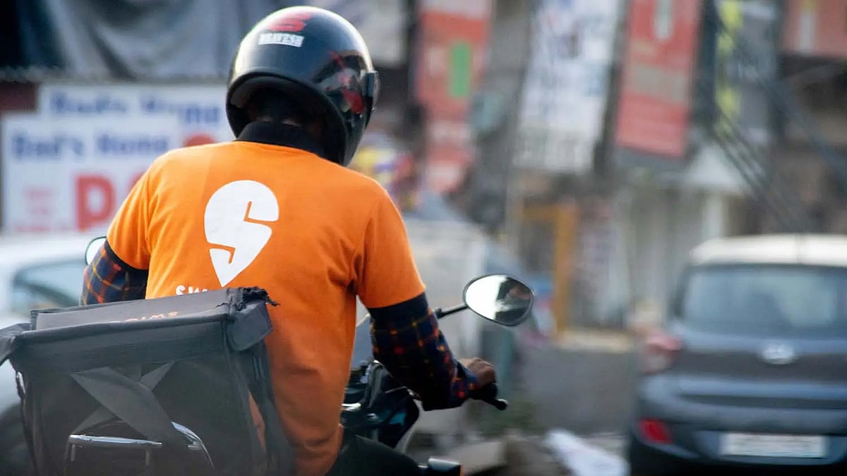 A delivery person riding a bike.