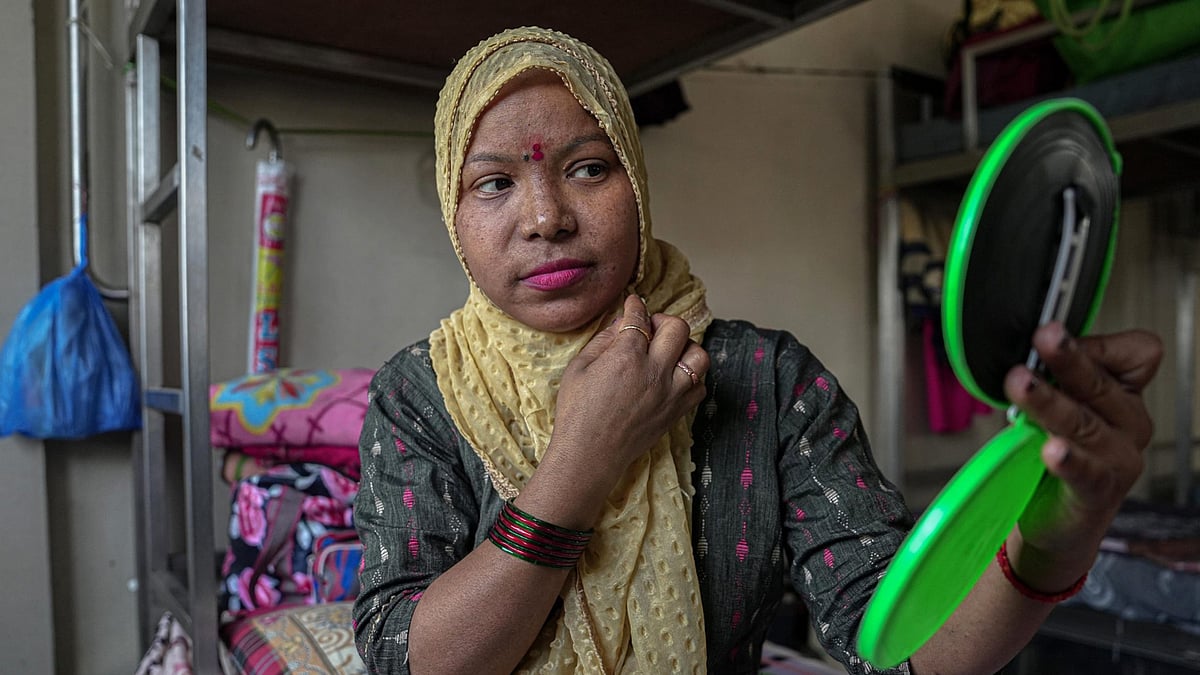 Tulasi Singh, 38, getting ready to be photographed at the Gadge Maharaj Dharamshala, Mumbai. 