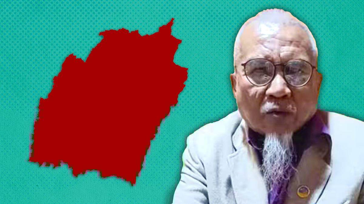 Journalist Yambem Laba with a map of Manipur.