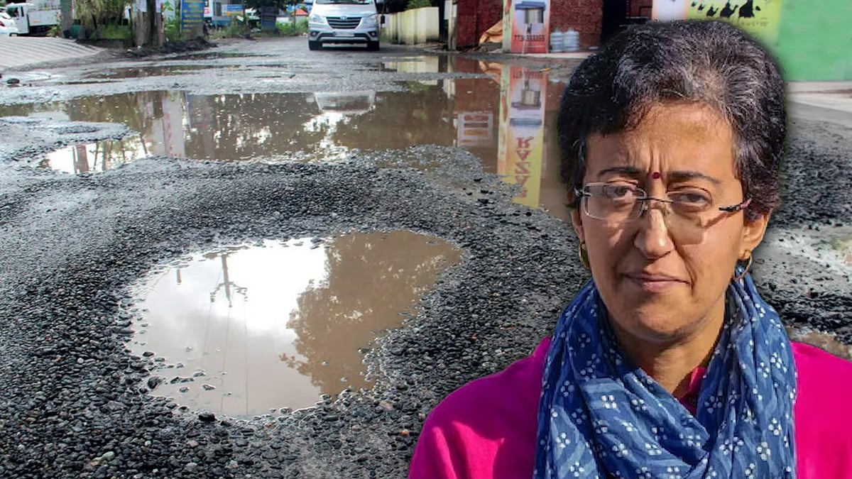Atishi's cutout with a picture of a potholed road in the background.