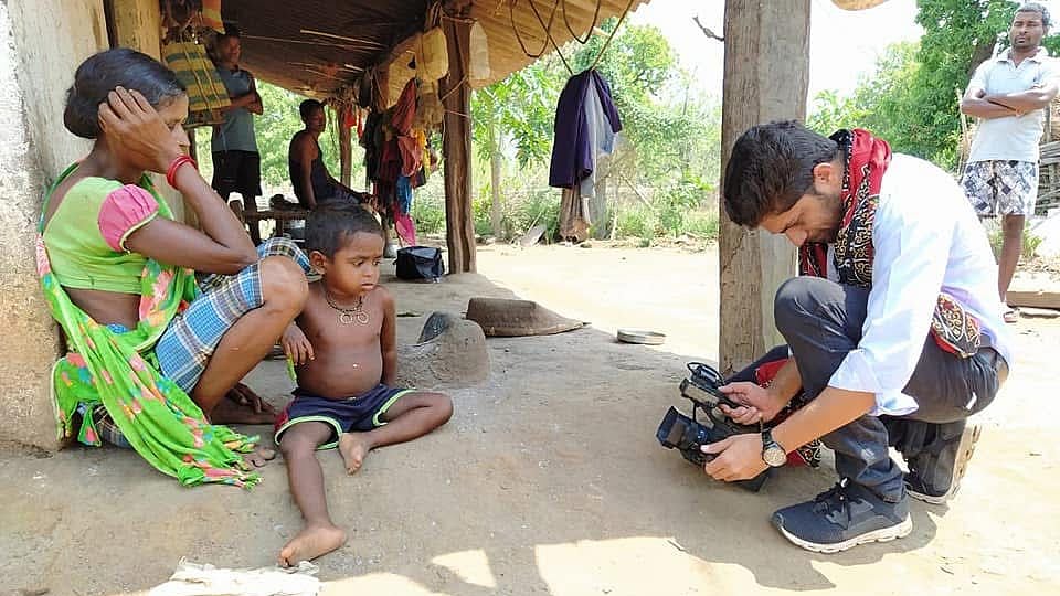 An old picture of Mukesh Chandrakar (right) on a reporting assignment.