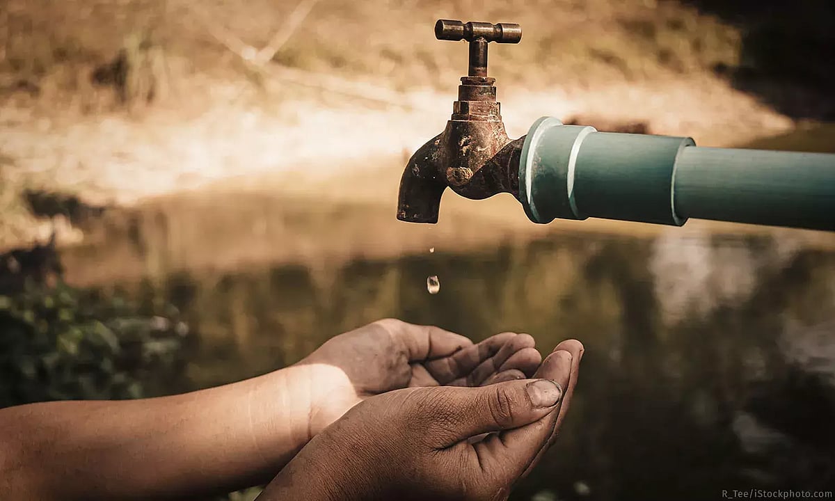 A hand extended under tap.