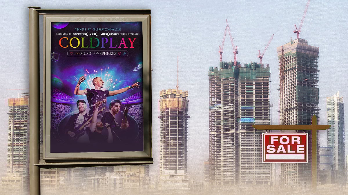 A billboard with the Coldplay world tour poster, with under-construction buildings behind it.