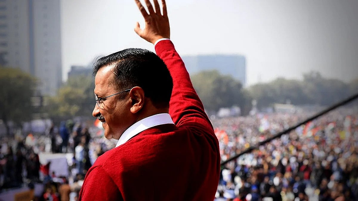 Arvind Kejriwal waving at a crowd.