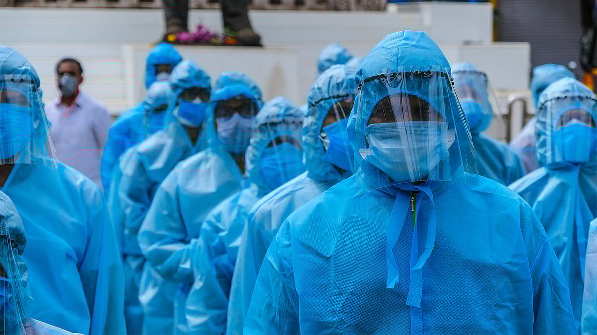 Healthcare workers wearing PPE and face shields. 