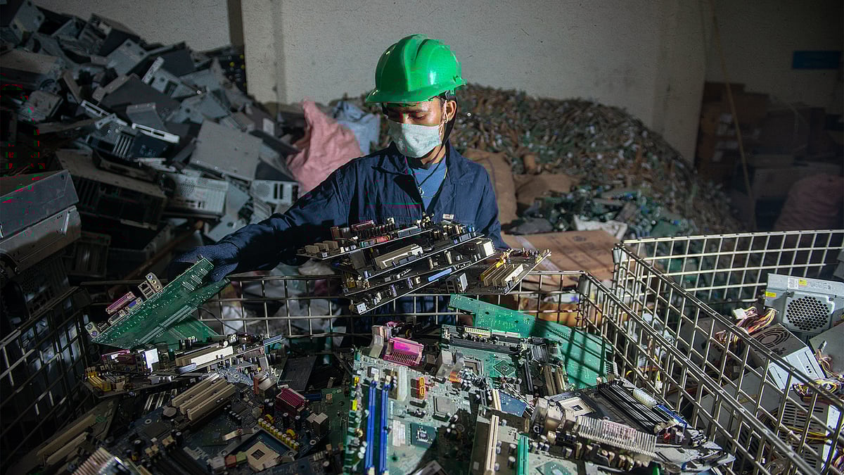 A worker segregates electronic waste at a recycling facility in Uttarakhand.