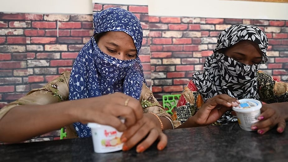 Whenever Harini Nayak (in the blue shawl) and her friend earn an incentive, they treat themselves to ice cream.