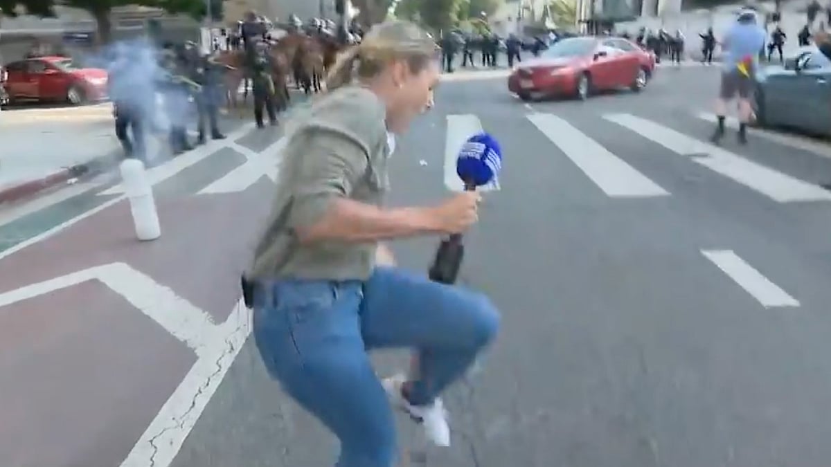 A screenshot showing journalist Lauren Tomasi being shot with a rubber bullet.