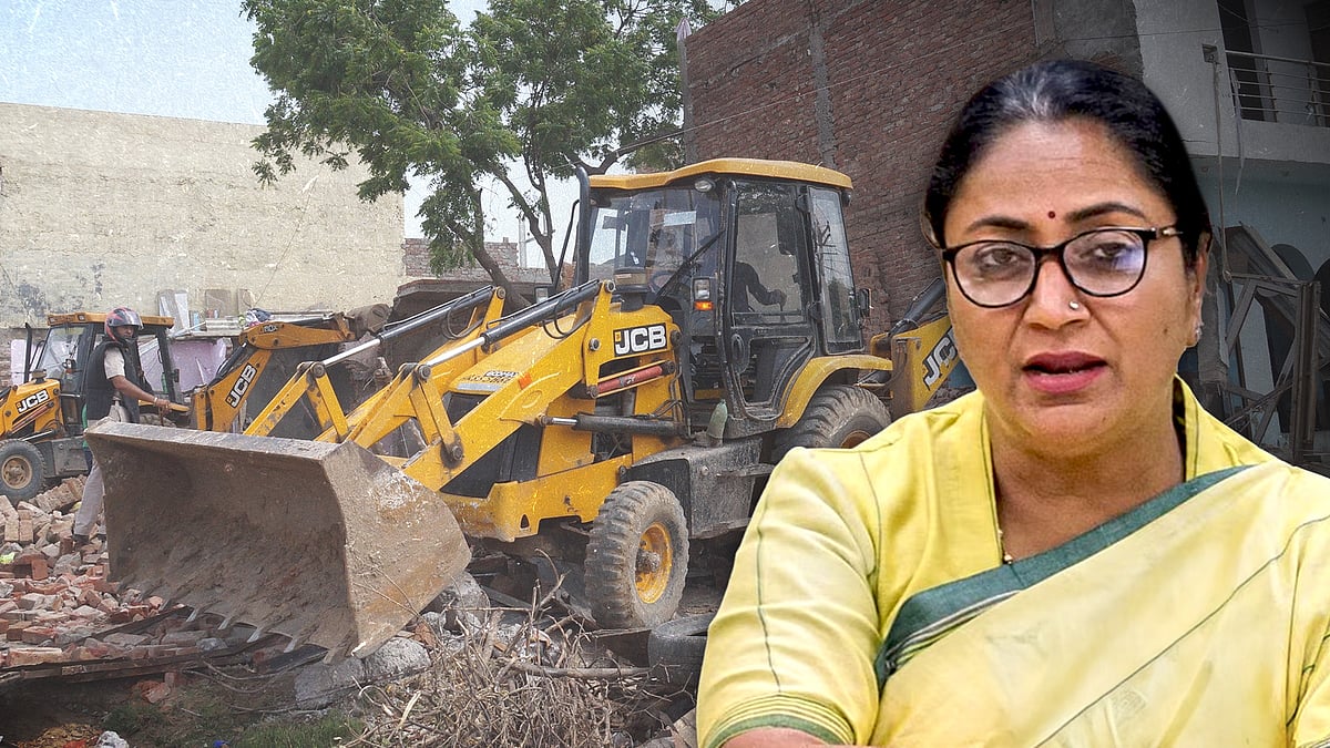 Delhi Chief Minister Rekha Gupta with a picture of a bulldozer.