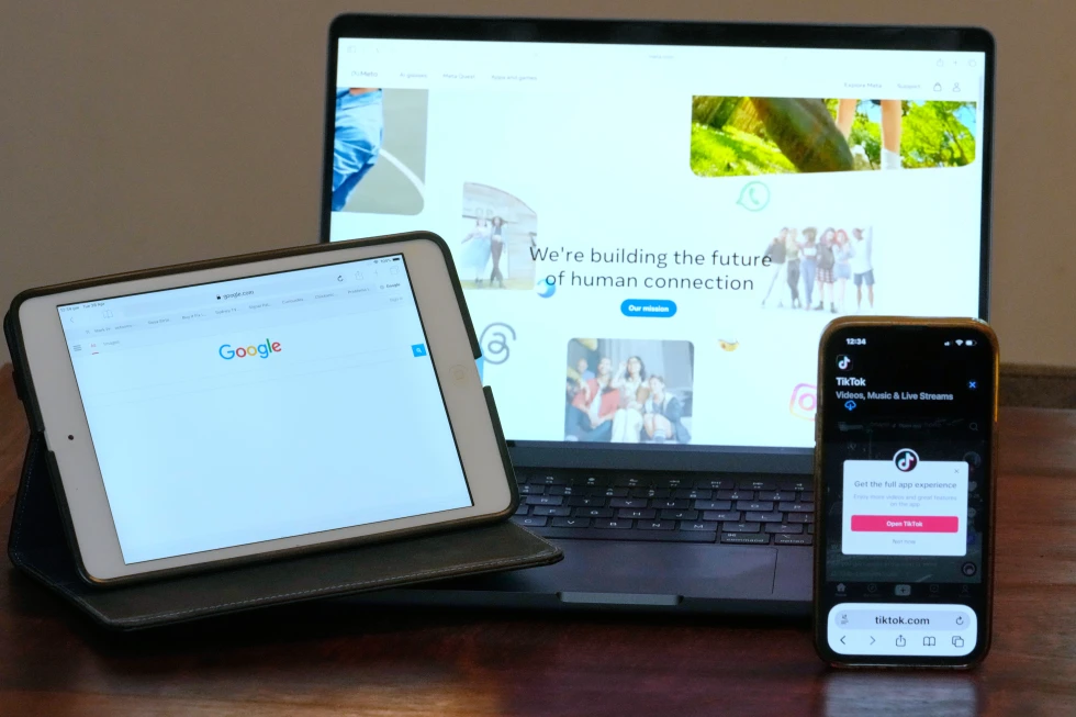 The home pages of Meta, Google and TikTok are displayed on devices in Sydney.