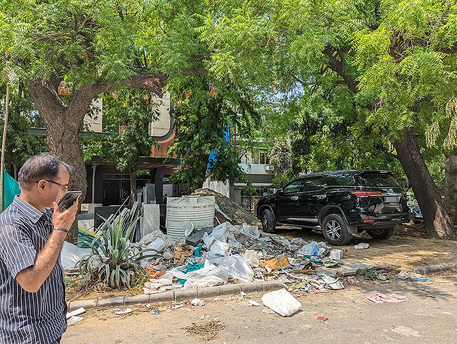 Construction debris dumped on a footath in Defence Colony
