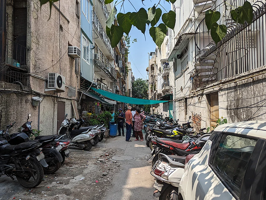 Parked bikes encroaching on footpaths in an alleyway of Defence Colony