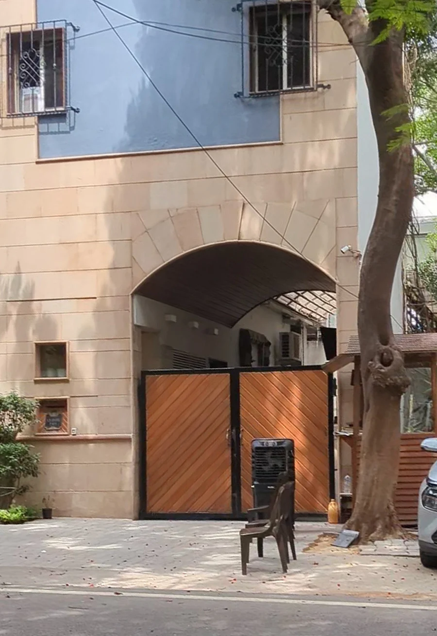 A footpath encroached by a driveway and guard booth
