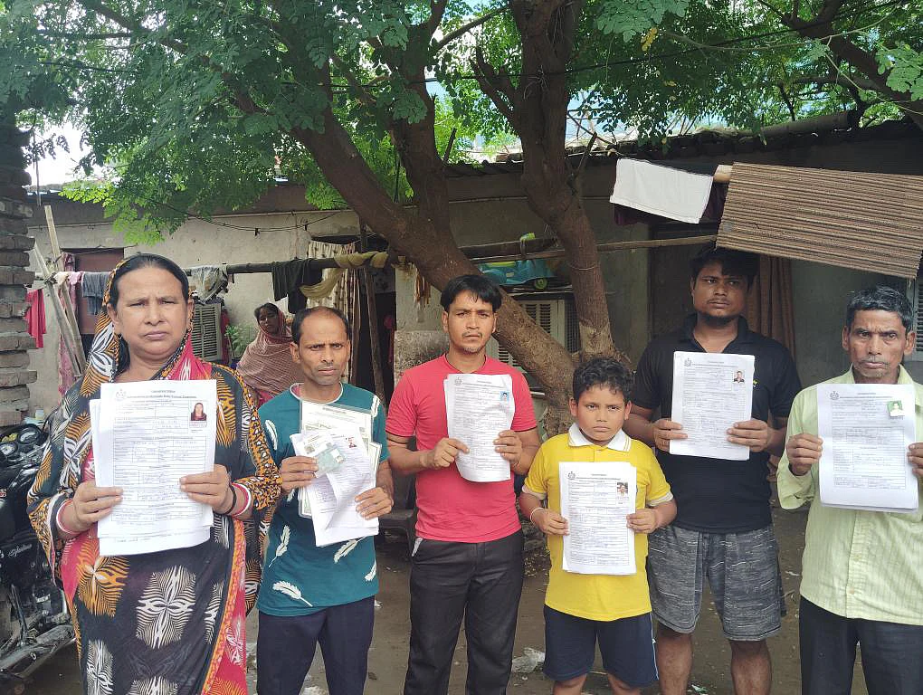 Bengali migrants in Gurugram holding their official documents