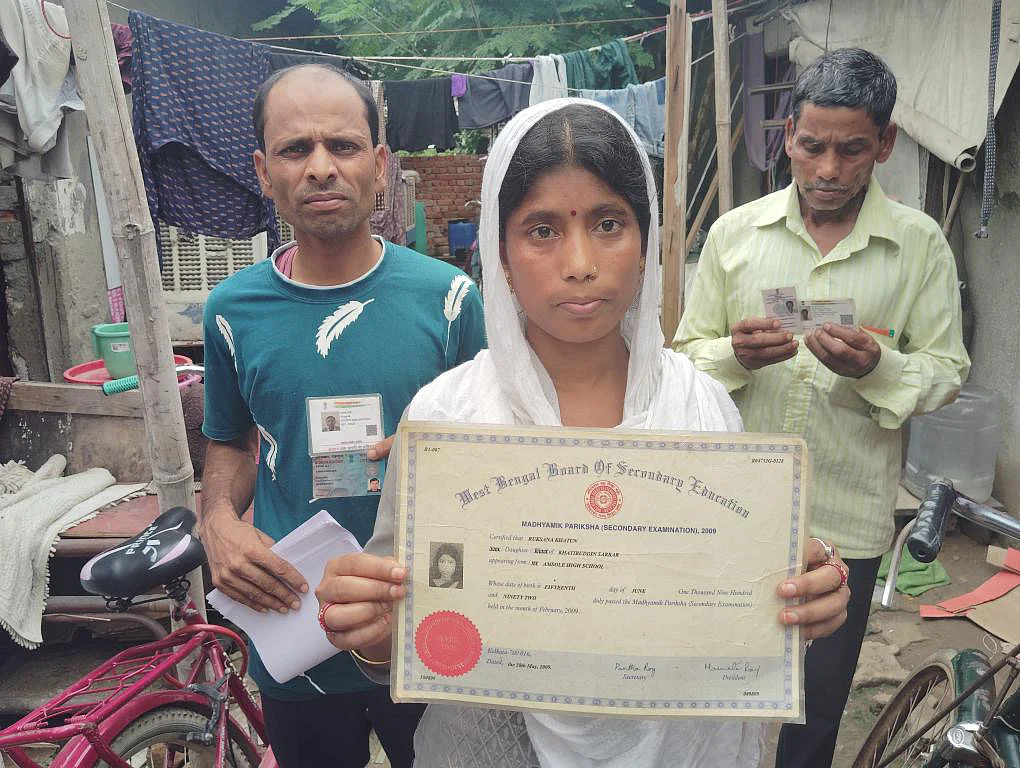 A resident shows her Class 10 ceritificate