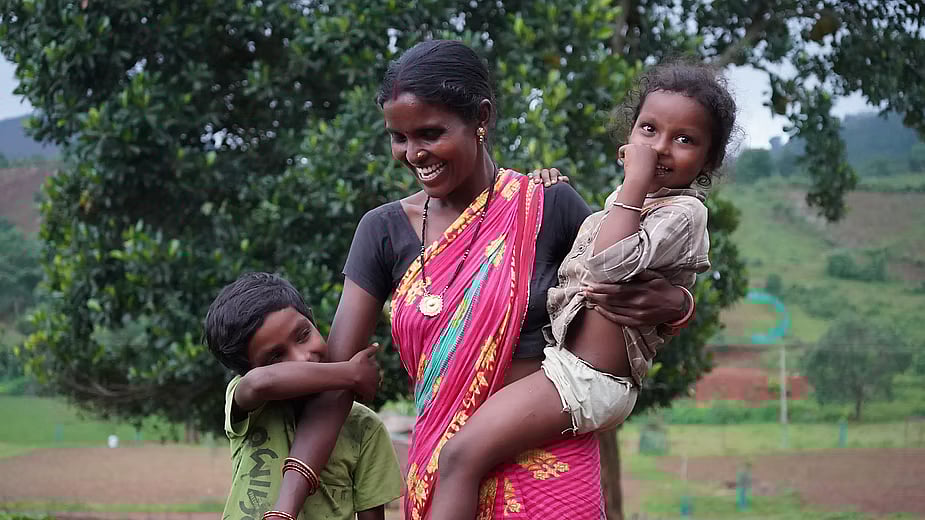Umakant Naik’s wife, Pushpanjali, with their two younger children. Two older sons study in residential schools.