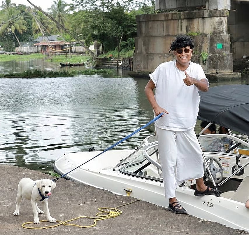 A photo of Boby Chemmanur walking his dog. 