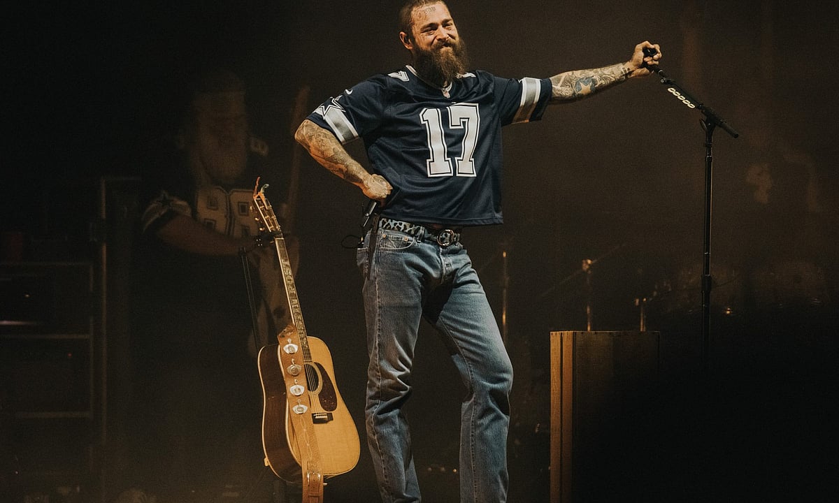 Post Malone holding the mike during a performance in Utah Concert