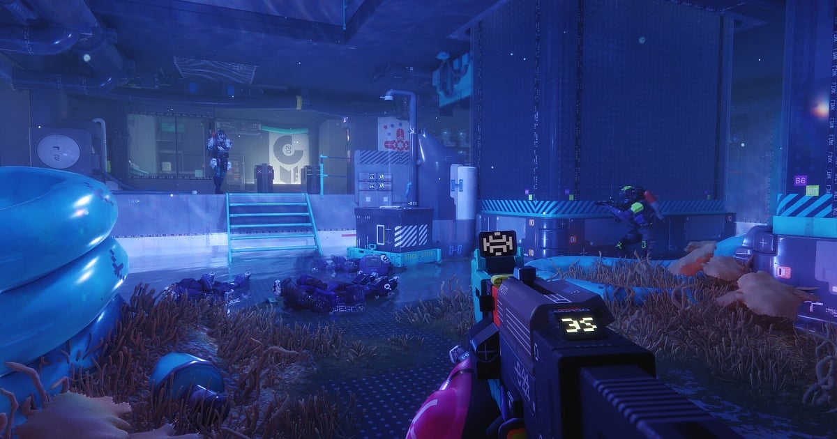 A first-person perspective of a player holding a futuristic assault rifle with a digital ammo counter displaying "35"in a neon-lit, underwater-themed industrial facility from Marathon. The scene features vibrant blue lighting, submerged corridors with coral-like growth, and enemy players positioned near cargo crates and elevated platforms.
