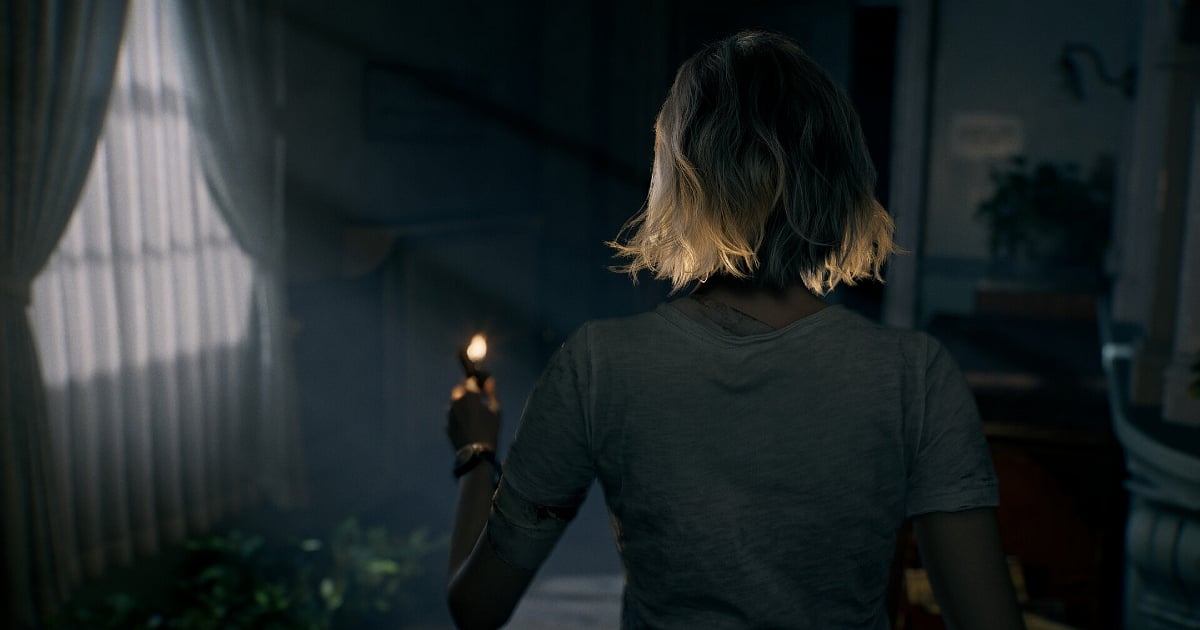 A rear-view, cinematic shot of a blonde woman standing in a dimly lit, eerie room. She holds a small lighter, the flame casting a warm glow on her hair and a bandage on her arm. Hazy light filters through a nearby window with white curtains, creating a tense, survival-horror atmosphere.