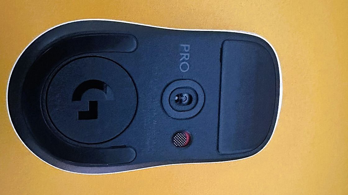 Bottom view of Logitech G Pro X2 Superlight gaming mouse showing the optical sensor, power button, and Logitech G logo
