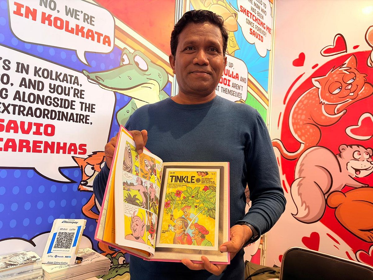 Savio Mascarenhas, Group Art Director for Amar Chitra Katha, holding Tinkle "Origins"