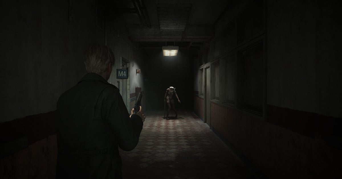 An intense over-the-shoulder shot of James Sunderland holding a handgun in a dark, grimy hospital hallway. In the distance, a twitching, distorted Bubble Head Nurse stands under a flickering overhead light, emerging from the shadows. The floor is covered in a dirty checkered tile pattern, enhancing the psychological horror aesthetic.