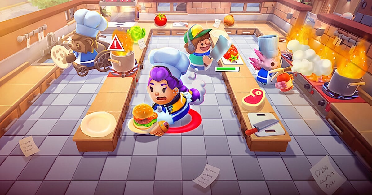 A vibrant, chaotic cartoon kitchen from the game Overcooked, featuring diverse chef characters—including a raccoon in a wheelchair and an axolotl—scrambling to cook amid kitchen fires and scattered food.