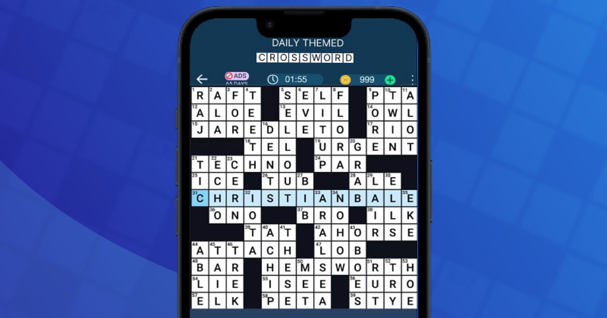 A smartphone displaying the interface of the Daily Themed Crossword mobile game. The crossword grid features celebrity names like Christian Bale, Jared Leto, and Hemsworth. The UI shows game progress, a timer, and a coin balance against a dark blue background.