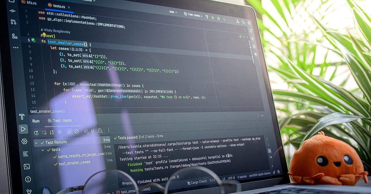 Open laptop displaying code during a debugging and QA process