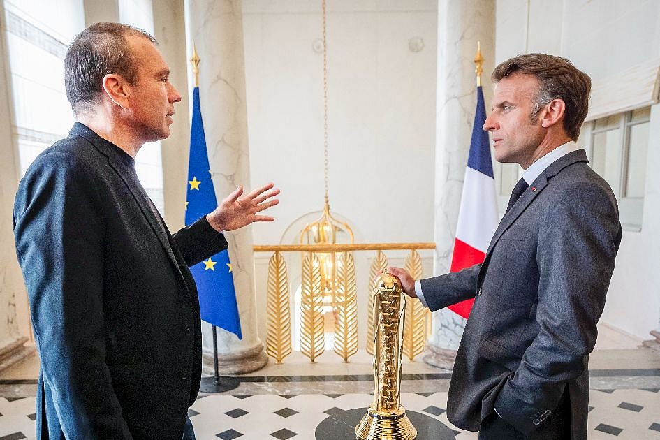 Esports Foundation CEO Ralf Reichert and French President Emmanuel Macron stand with the EWC Club Championship trophy at the Élysée Palace ahead of the EWC 2026 Paris announcement