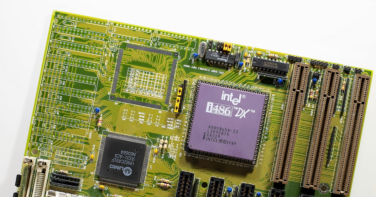 Detailed close-up image of a vintage Intel i486 DX computer motherboard from the late 1980s or early 1990s, featuring a prominently mounted purple Intel i486 DX processor chip at the center-right of the board.