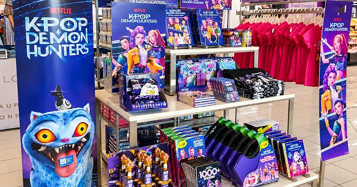KPop Demon Hunters merchandise display featuring clothing, accessories, toys, books, and character-themed products in a retail store.