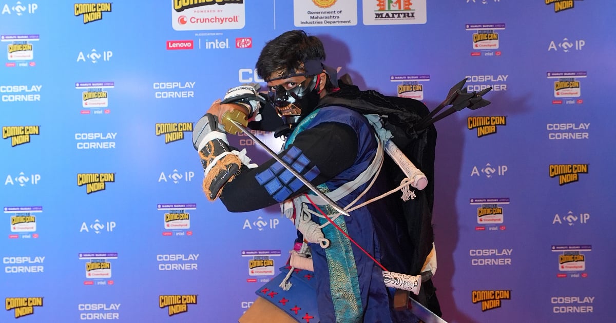 Cosplayer in a detailed ninja-inspired costume poses at Comic Con India’s Cosplay Corner.