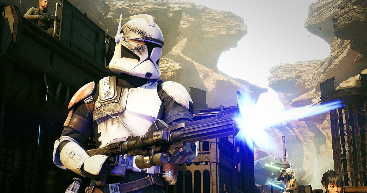 A promotional image of Star Wars Zero Company featuring a battle-scarred clone trooper with orange shoulder armor firing a heavy blaster rifle, emitting a bright blue blast. They stand in a rocky, sunlit canyon environment. Behind them to the left, another soldier looks down from a dark metal structure, while additional figures are partially visible in the lower right background.