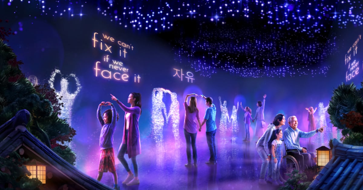 Families and visitors explore a glowing KPop Demon Hunters-themed immersive space with Korean-inspired visuals and illuminated displays.