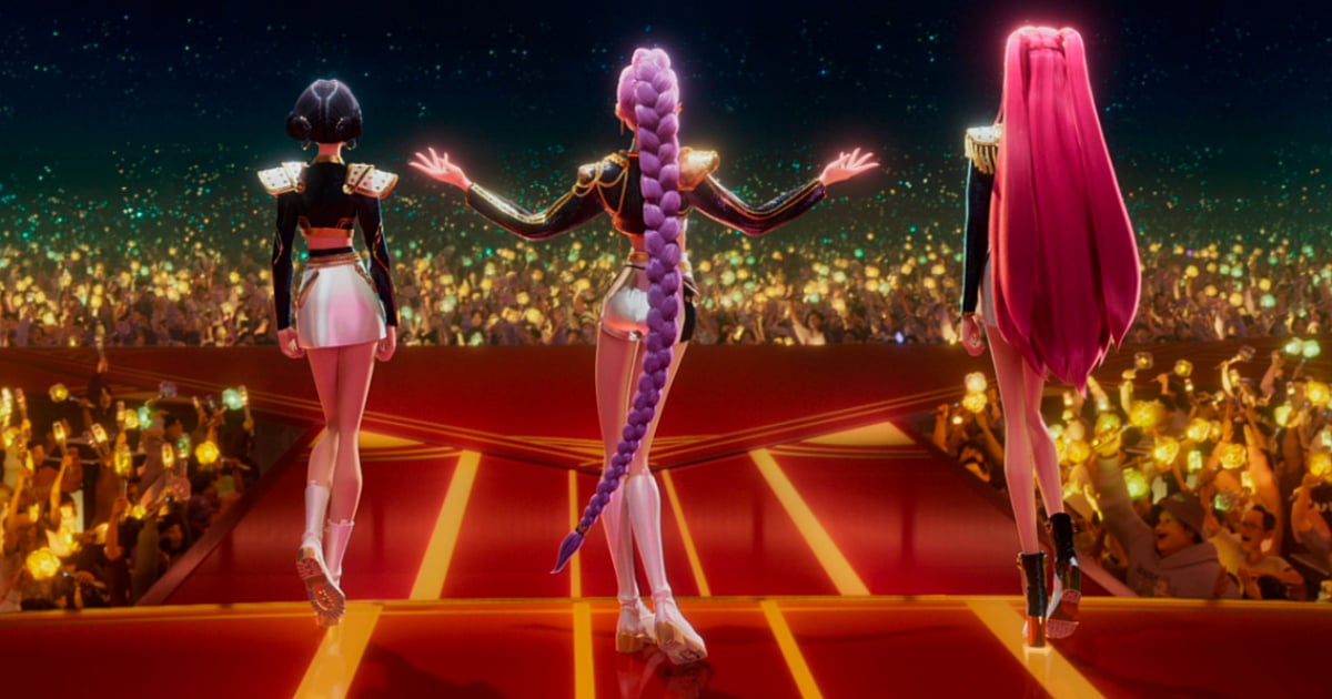 Netflix’s KPop Demon Hunters showing HUNTR/X performing on stage before a large audience.