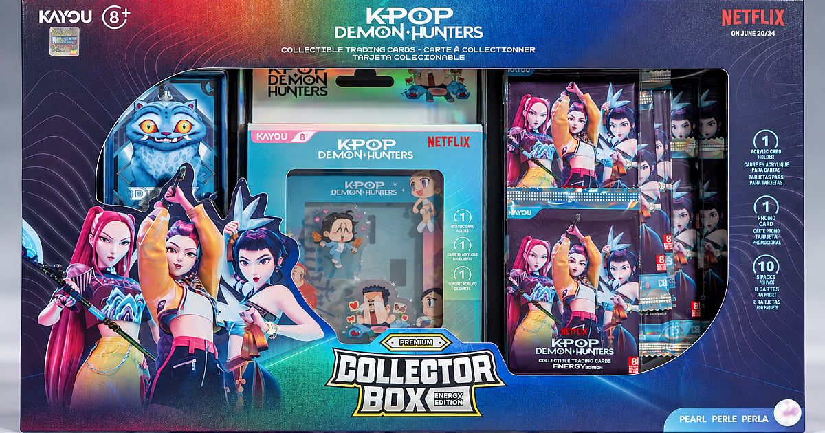 KAYOU’s KPop Demon Hunters Energy Edition Collector Box featuring HUNTR/X character artwork, a blue creature illustration, collectible trading card packs, an acrylic card holder, and premium packaging with multicolored graphics.