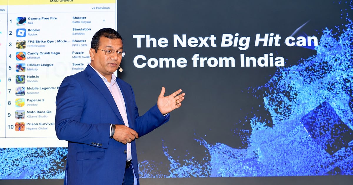 Roblox India managing director, Sunil Rao, speaks at the UNBOX ROBLOX event in New Delhi, with a screen displaying the message “The Next Big Hit can Come from India” and a mobile game ranking chart in the background.